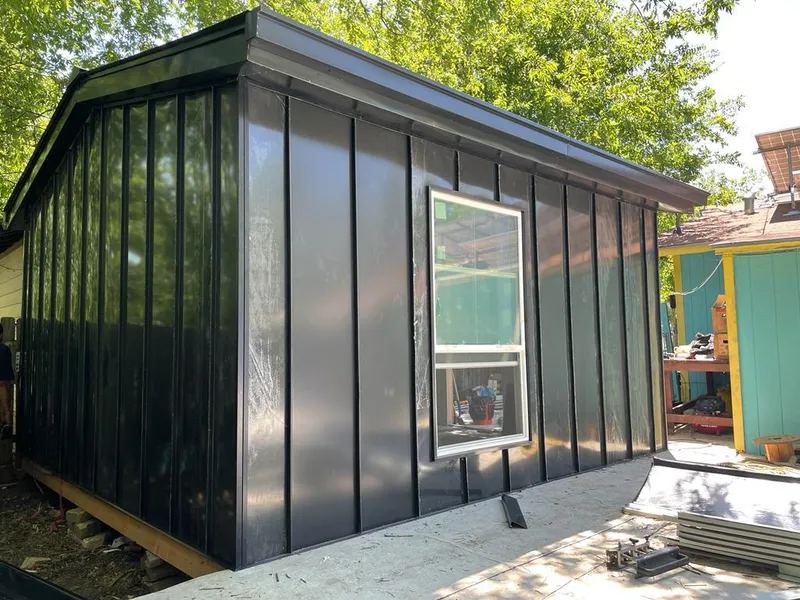 Black standing seam metal wall panels for Metal Roof Installation in The Village